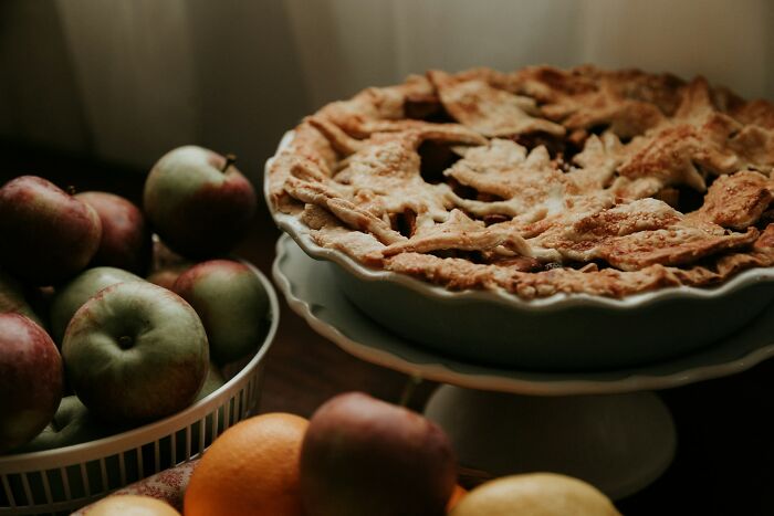Delicious apple pie with a lattice crust and fresh apples, showcasing cool facts about the universe's bounty.