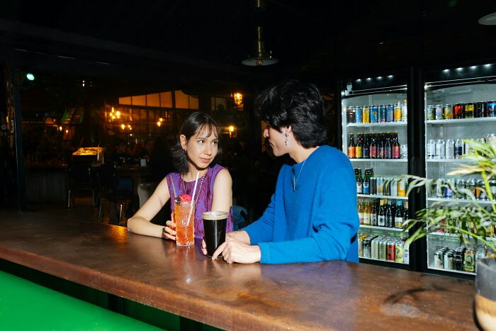 A couple having drinks while discussing marriages collapsed