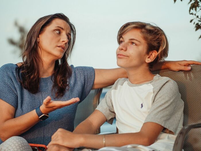 A mother talking seriously to her teenager, hinting at family challenges why marriages collapsed.