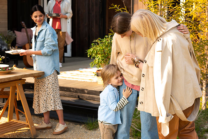 A woman on vacation with family, including a nanny and children. This vacation nanny helps her relax. A woman on vacation with family, including a nanny and children. This vacation nanny helps her relax.
