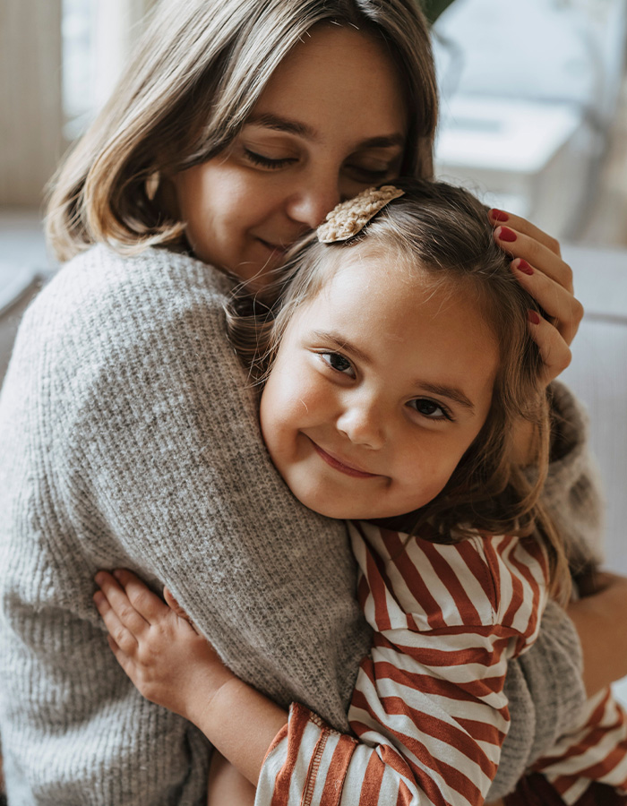 A mother embraces her happy little girl, highlighting the innocence that retail giants should protect from terrible messages. A mother embraces her happy little girl, highlighting the innocence that retail giants should protect from terrible messages.