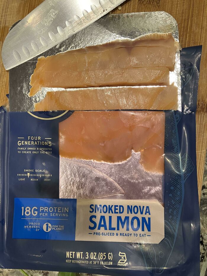 A package of smoked salmon with deceptive packaging showing very few actual slices of fish.