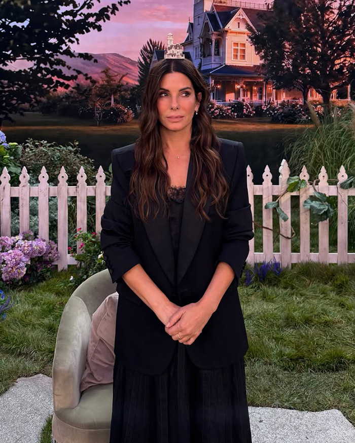 Sandra Bullock looking glamorous in a black suit, discussing her extreme measures to keep her son a secret. Sandra Bullock looking glamorous in a black suit, discussing her extreme measures to keep her son a secret.