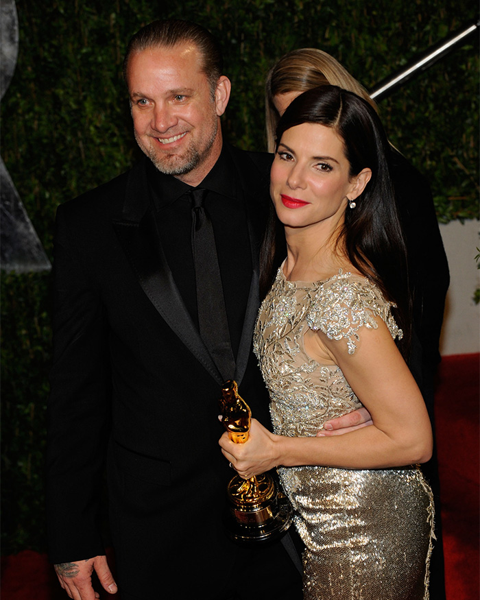 Sandra Bullock with Jesse James, holding an award, amidst cheating scandal. Sandra Bullock with Jesse James, holding an award, amidst cheating scandal.