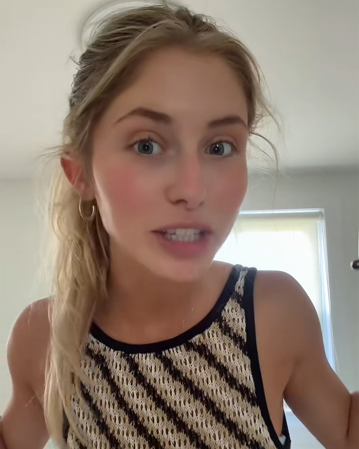 An attractive woman with blonde hair and a patterned top, looking intently at the camera.