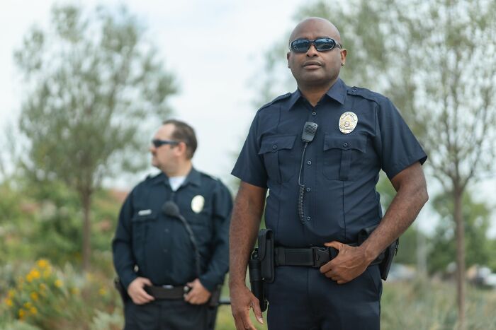 A police officer showing alert behaviors on duty with his partner