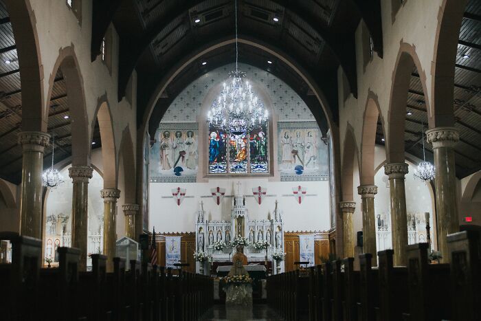 Interior of ornate church with stained glass highlighting secret history