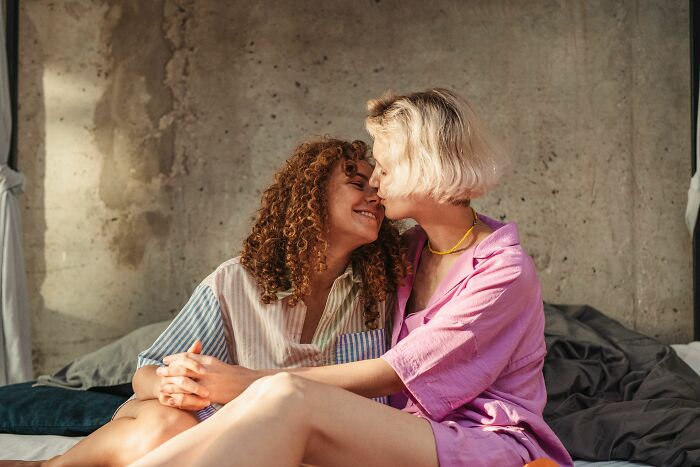 Couple sharing intimate moment sitting close together indoors