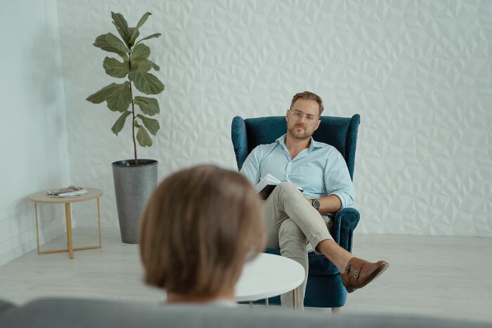 Man sitting in chair during a therapy session sharing secrets accidentally discovered