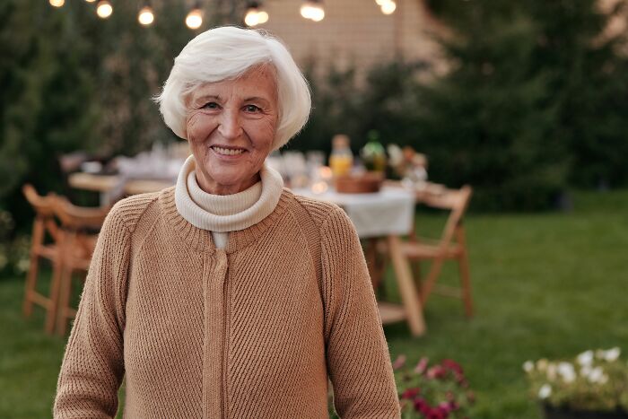 Smiling elderly woman outdoors representing secrets people accidentally discovered