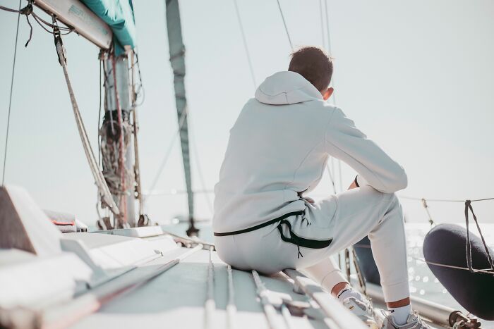Man sitting on sailboat deck reflecting accidental secrets discovery
