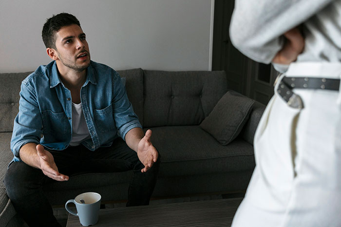 A man with a serious expression, gesturing, as a buddy thinks his friend needs a hot GF and a weight-loss coach. A man with a serious expression, gesturing, as a buddy thinks his friend needs a hot GF and a weight-loss coach.