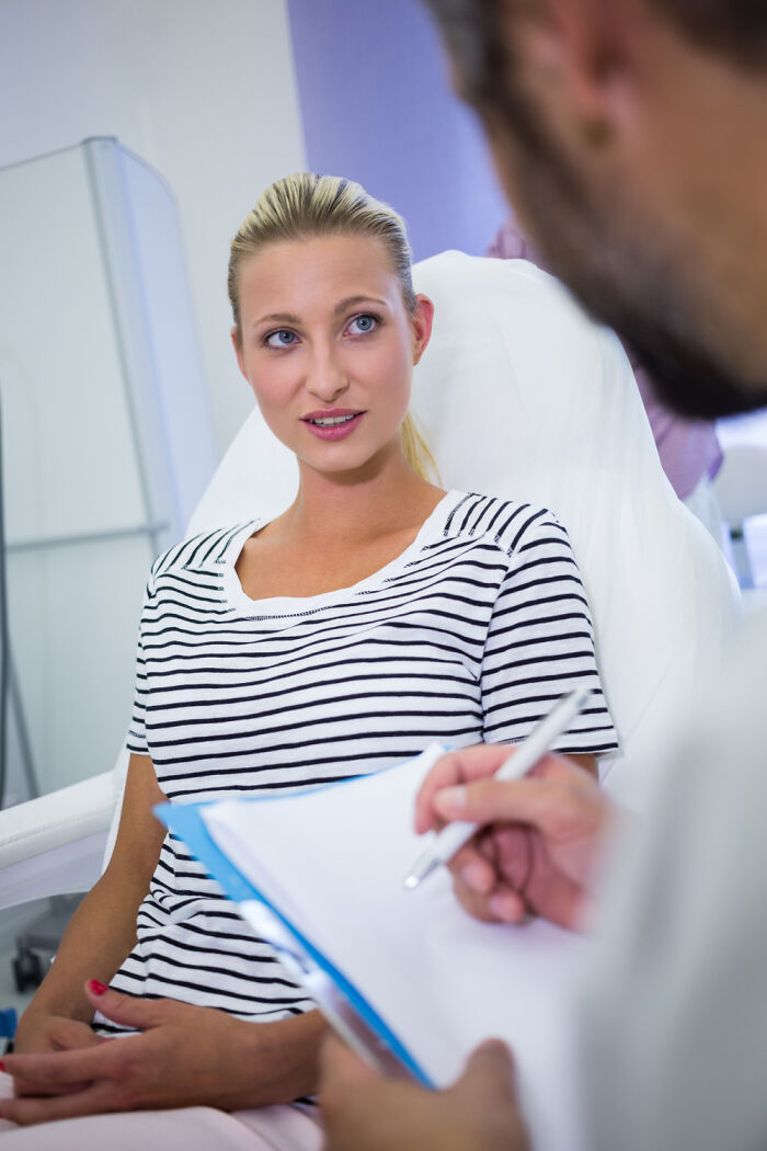 Woman discussing concerns with doctor representing sexist treatment from doctors