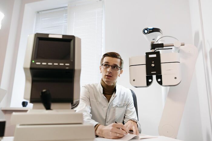 Male doctor in clinic showing sexist treatment in medical consultation
