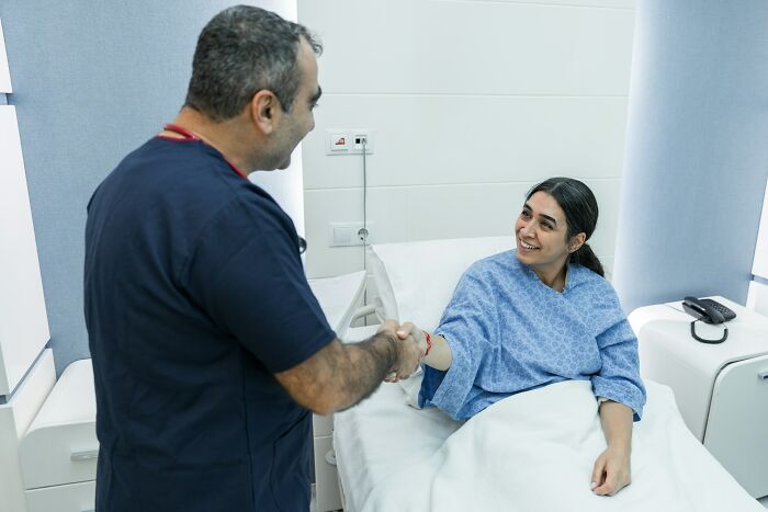 Female patient shaking hands with doctor symbolizing women's experience with sexist treatment