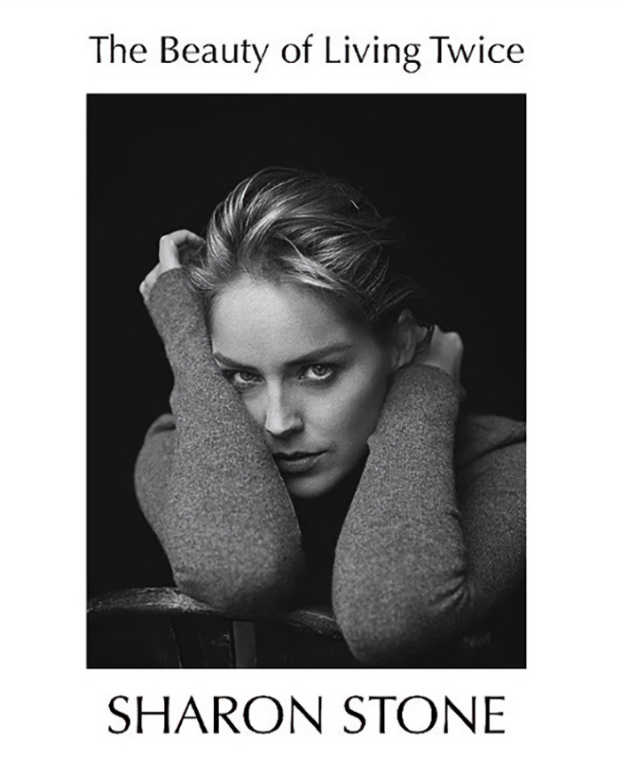 Black and white portrait of A-list actress Sharon Stone with her hands near her head.