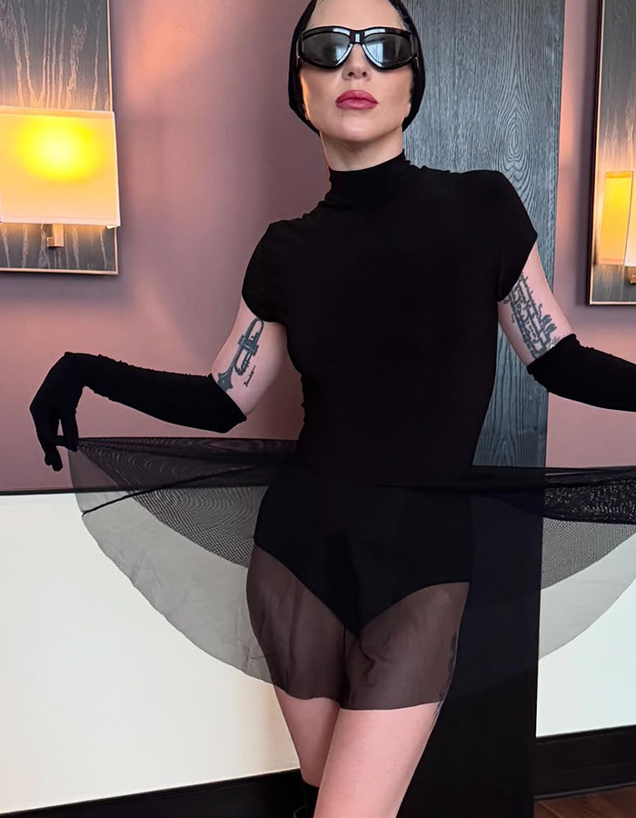 Lady Gaga expecting first baby. She wears black, a full black outfit, with black sunglasses.