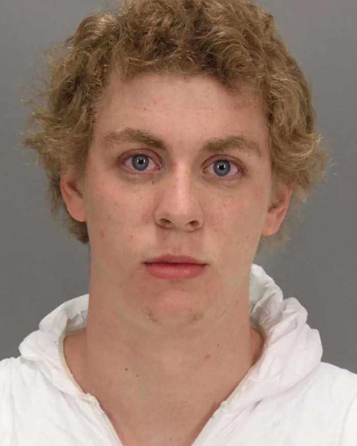 Mugshot of Brock Turner with curly blonde hair wearing a white top. Mugshot of Brock Turner with curly blonde hair wearing a white top.