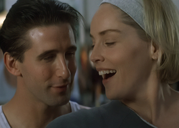 Close-up of Billy Baldwin looking at an actress, who is smiling.