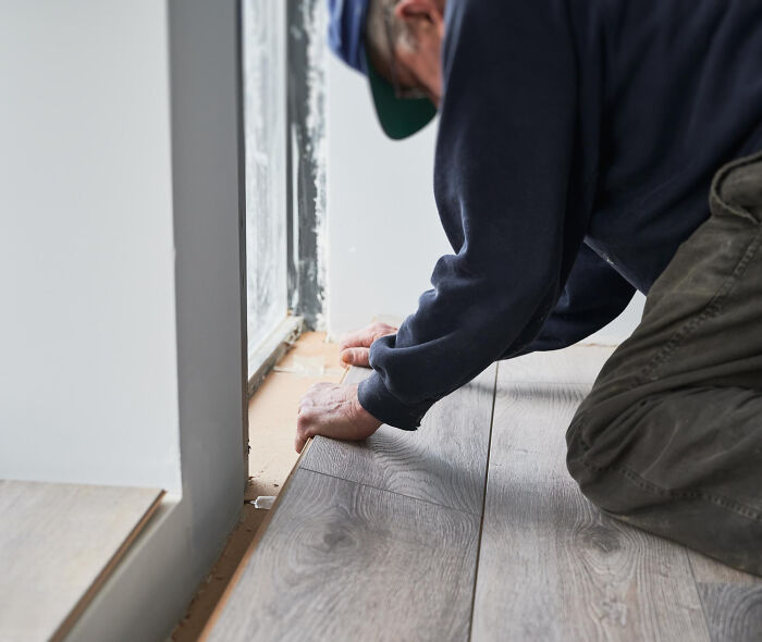 A man working on a floor in a small town, an everyday scene potentially hiding shocking secrets.