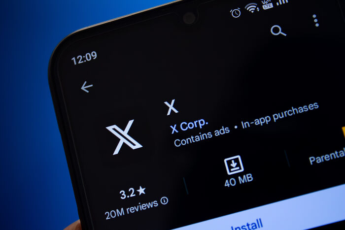 A smartphone displaying the X Corp. app, potentially related to a midlife crisis new career path.