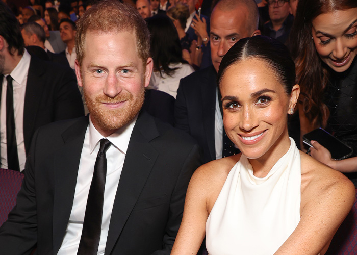 Meghan Markle and Prince Harry attend an event in the UK, smiling at the camera, during their UK return. Meghan Markle and Prince Harry attend an event in the UK, smiling at the camera, during their UK return.