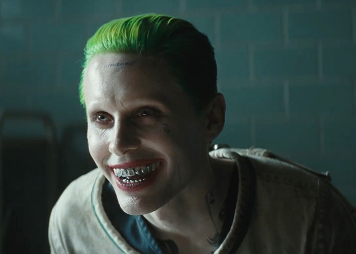 Jared Leto as Joker, displaying appalling on-set behavior, with green hair and a sinister grin, showcasing method acting. Jared Leto as Joker, displaying appalling on-set behavior, with green hair and a sinister grin, showcasing method acting.