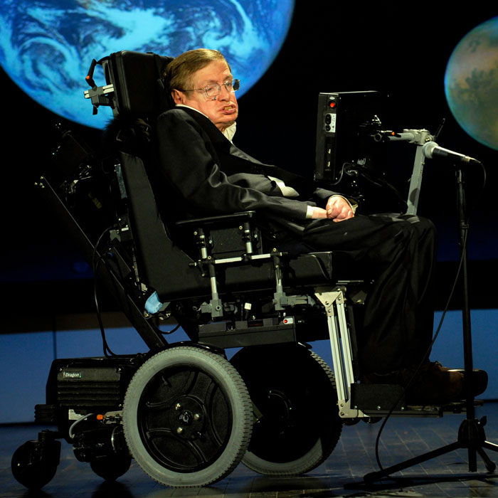 Stephen Hawking in his wheelchair on stage, delivering a warning about AI. Stephen Hawking in his wheelchair on stage, delivering a warning about AI.