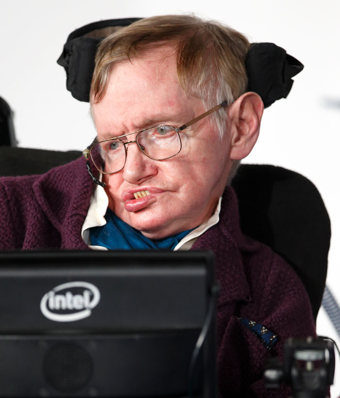 Stephen Hawking in his wheelchair, wearing glasses, warning about AI. Stephen Hawking in his wheelchair, wearing glasses, warning about AI.