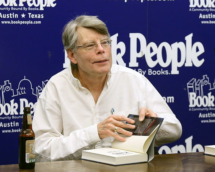 Stephen King signing his book at a book event, showcasing his pulled book publication. Stephen King signing his book at a book event, showcasing his pulled book publication.