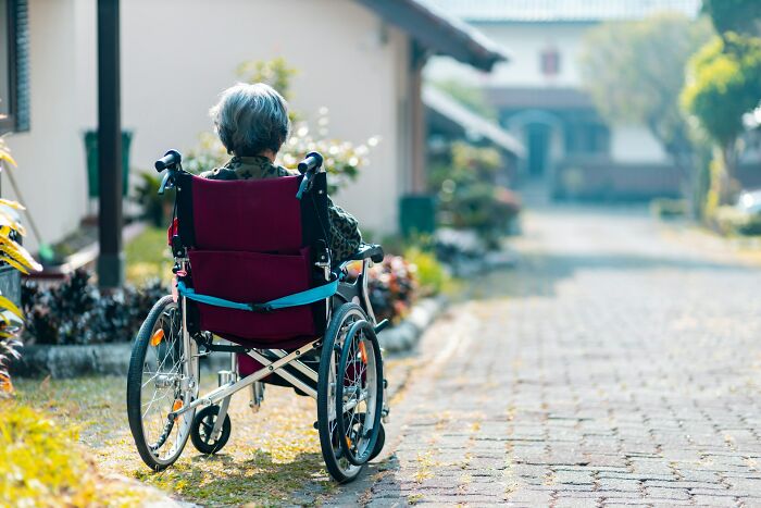 An elderly person in a wheelchair, illustrating historical geriatric medical practices