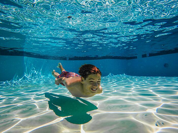 A boy swimming underwater in a pool, representing weird things people were not prepared to see.