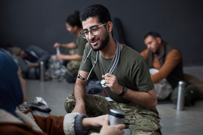 Man in military uniform and glasses, appearing as a medic, speaking to someone. Parents create Facebook group. Man in military uniform and glasses, appearing as a medic, speaking to someone. Parents create Facebook group.