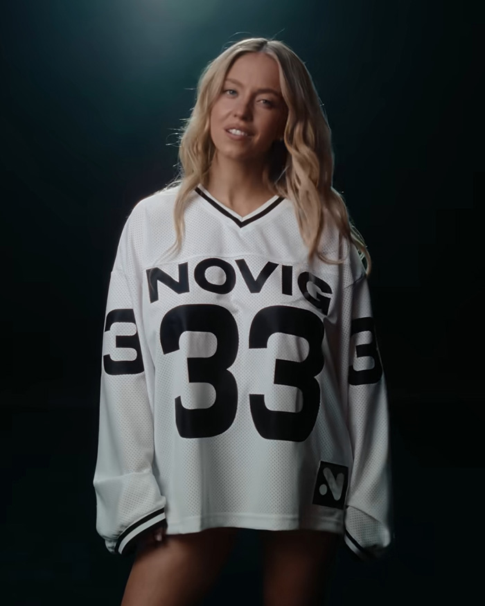 Sydney Sweeney in a white football jersey, posing for her ad campaign, sparking a response after backlash. Sydney Sweeney in a white football jersey, posing for her ad campaign, sparking a response after backlash.