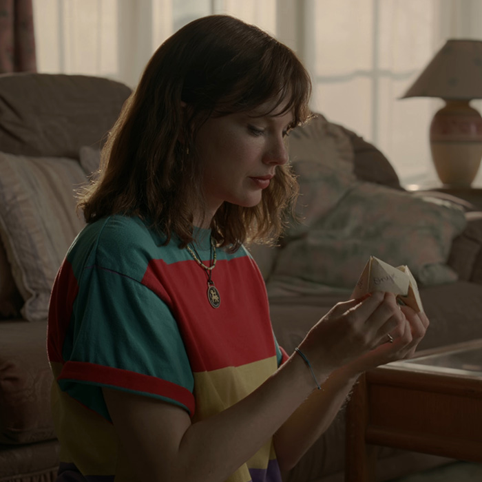 Taylor Swift holding a paper fortune teller game, highlighting Taylor Swift Taylor Swift holding a paper fortune teller game, highlighting Taylor Swift