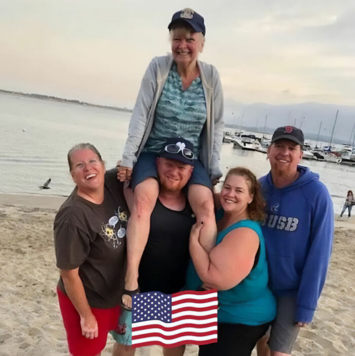 A happy dad of 3 on a family beach trip with an American flag graphic, prior to his cruise ship tragedy A happy dad of 3 on a family beach trip with an American flag graphic, prior to his cruise ship tragedy