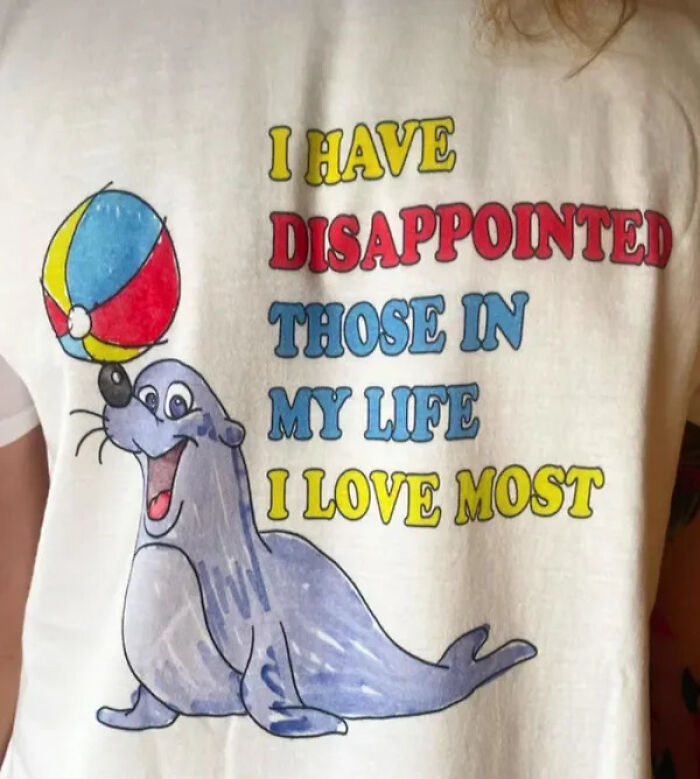 A t-shirt with a seal balancing a ball and a quote, one of many unhinged secondhand finds.