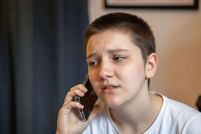 Concerned wheelchair-bound teen on a phone call, advocating for accessibility. Concerned wheelchair-bound teen on a phone call, advocating for accessibility.