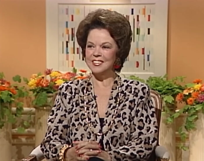 Shirley Temple in leopard print top smiling, telling new facts