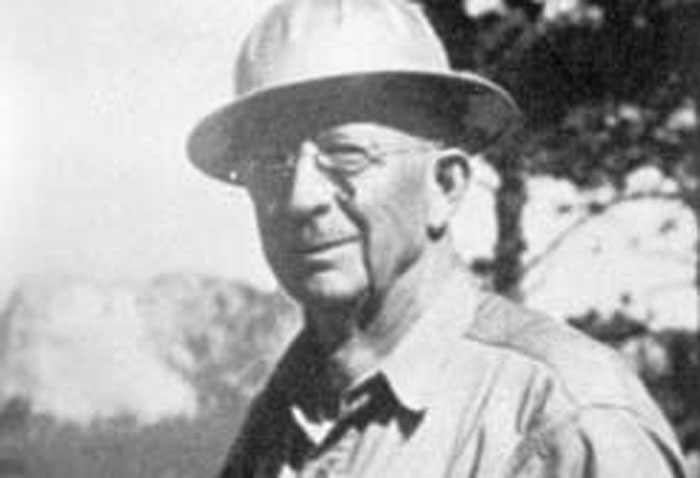 Black and white portrait of an older man in a hat, learning new facts