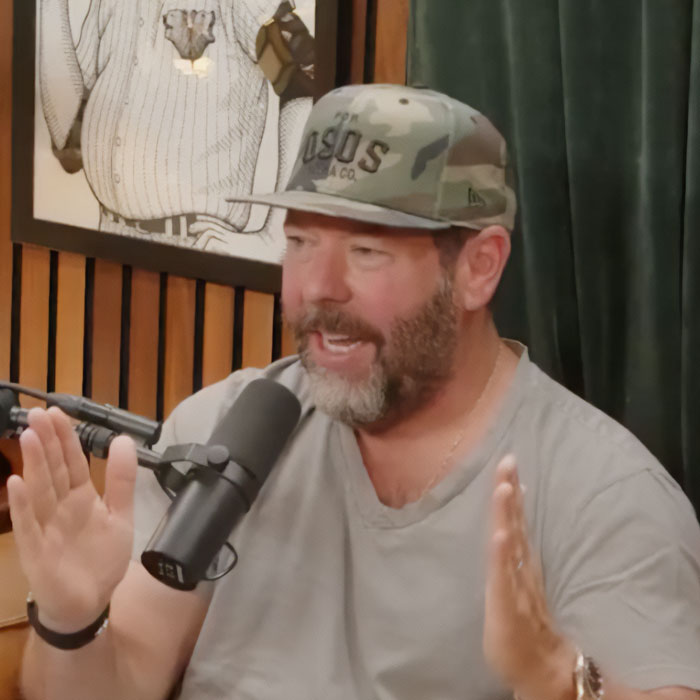 Bert Kreischer gesturing with his hands during a podcast interview. Bert Kreischer gesturing with his hands during a podcast interview.