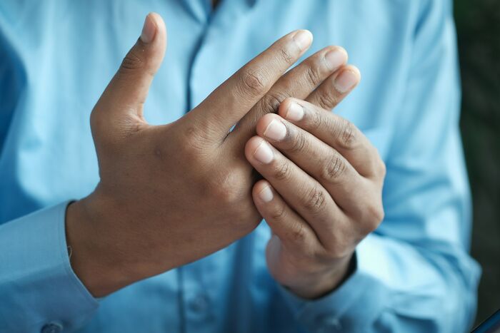 Close up of hands massaging joints, symbolizing physical therapy and medical practices