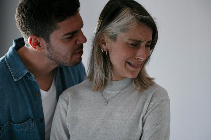 A woman crying as a man yells at her, depicting a toxic relationship ending for a woman. A woman crying as a man yells at her, depicting a toxic relationship ending for a woman.
