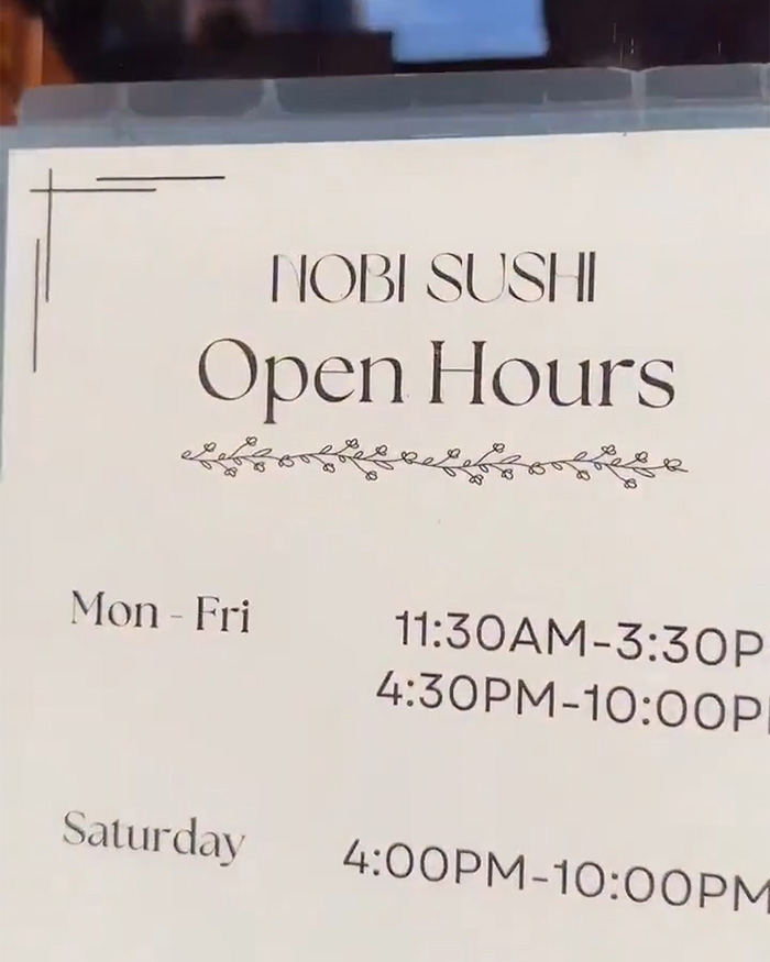 Sign with the open hours for Nobi Sushi, the Japanese restaurant involved in the trans woman controversy.