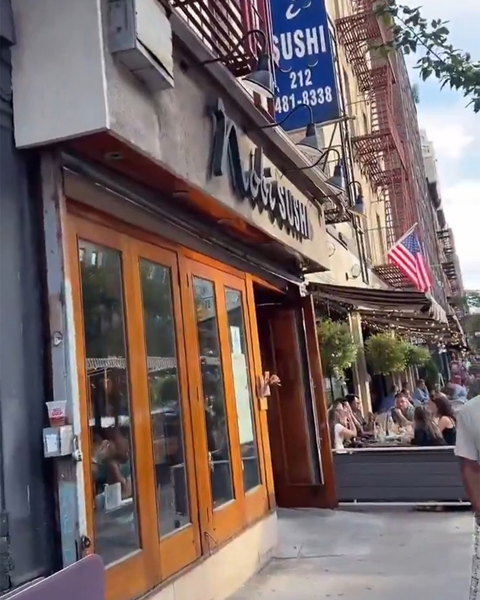 Japanese Restaurant exterior, an American flag outside, highlighting the cultural debate around the trans woman incident.