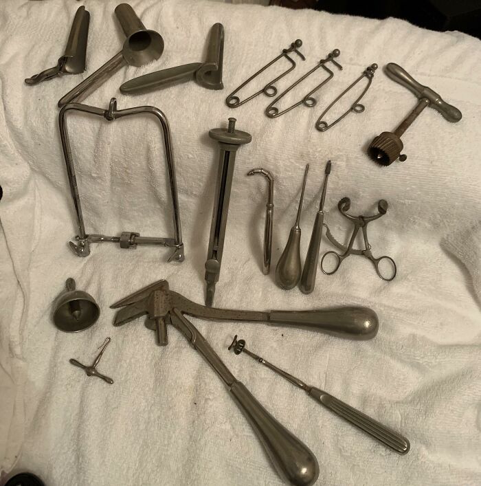 A collection of old, metallic surgical tools showing how much medicine has changed over time.