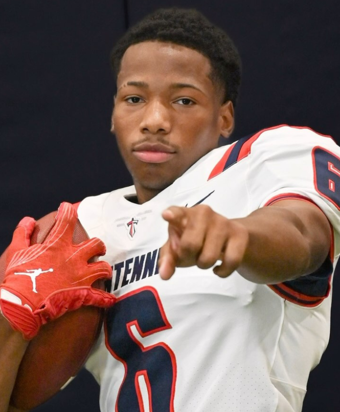 Young football player points to camera, linked to court documents on Karmelo Anthony's hateful texts.