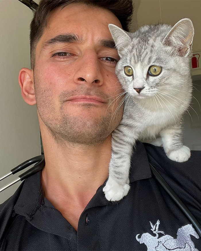 A vet with a stethoscope around his neck looks at the camera, a cute grey tabby kitten on his shoulder with its paw on his shirt. The vet shares ridiculous pet names. A vet with a stethoscope around his neck looks at the camera, a cute grey tabby kitten on his shoulder with its paw on his shirt. The vet shares ridiculous pet names.