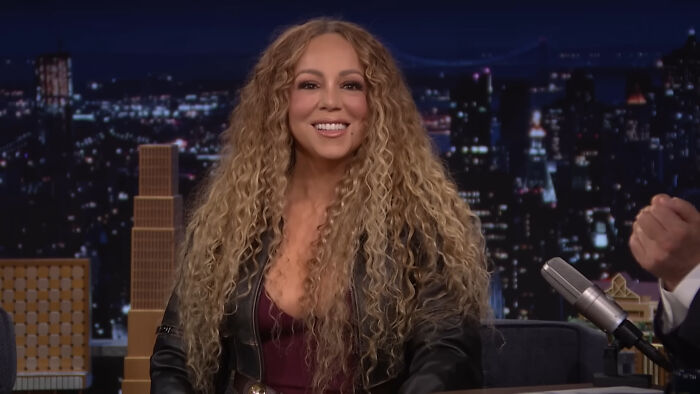 Mariah Carey smiling during an interview, related to celebrity encounters
