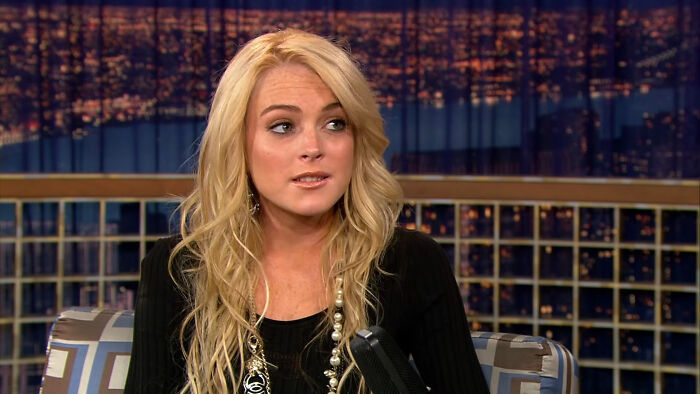 Lindsay Lohan during a talk show appearance talking about celebrity encounters.
